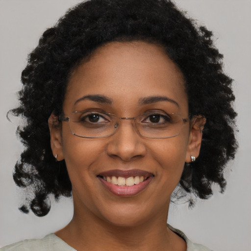 Joyful black adult female with short  brown hair and brown eyes