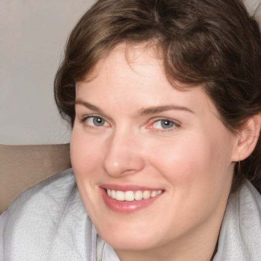 Joyful white young-adult female with medium  brown hair and blue eyes