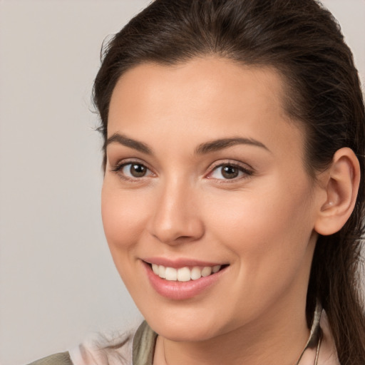 Joyful white young-adult female with medium  brown hair and brown eyes