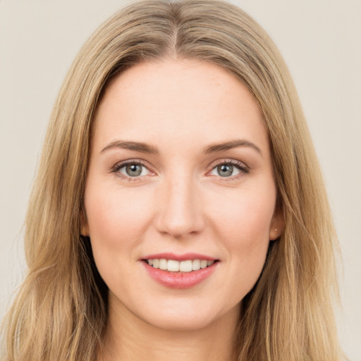 Joyful white young-adult female with long  brown hair and green eyes