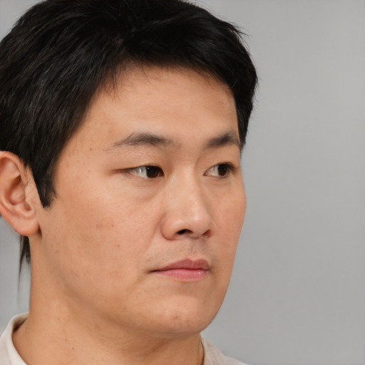 Neutral asian young-adult male with short  brown hair and brown eyes