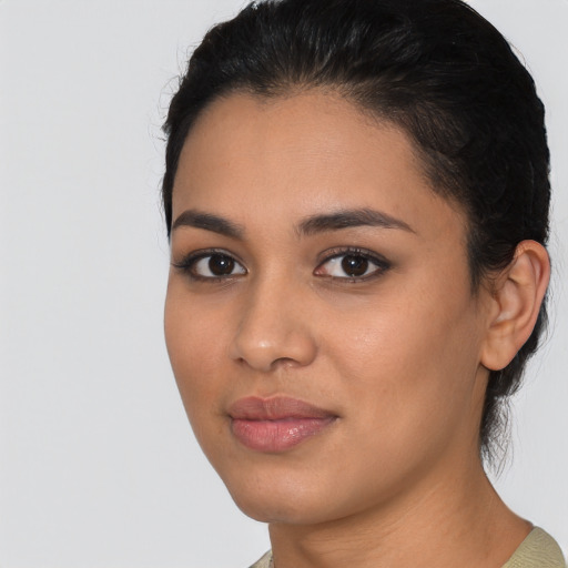 Joyful latino young-adult female with medium  black hair and brown eyes