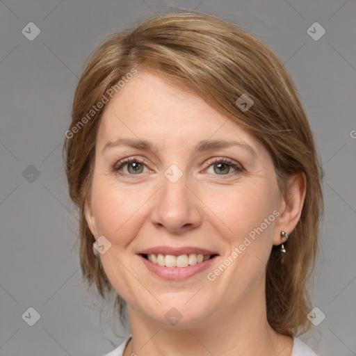 Joyful white adult female with medium  brown hair and grey eyes