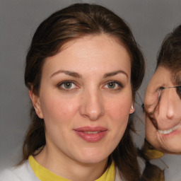 Joyful white adult female with medium  brown hair and brown eyes