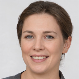 Joyful white adult female with medium  brown hair and grey eyes