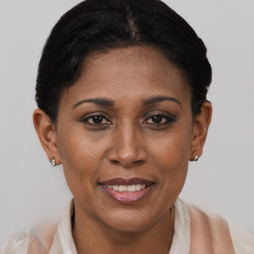 Joyful black adult female with short  black hair and brown eyes