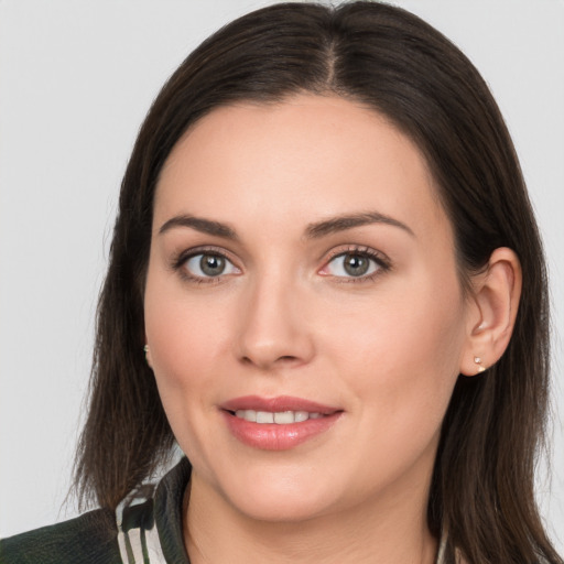 Joyful white young-adult female with long  brown hair and brown eyes