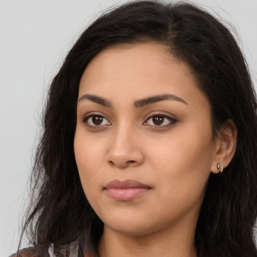 Neutral latino young-adult female with long  brown hair and brown eyes