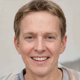 Joyful white adult male with short  brown hair and grey eyes