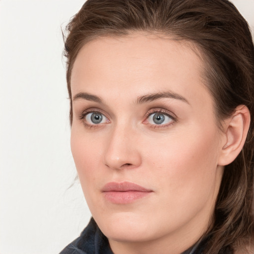 Joyful white young-adult female with long  brown hair and blue eyes