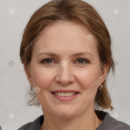 Joyful white adult female with medium  brown hair and grey eyes