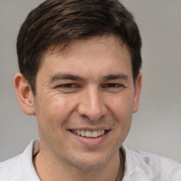 Joyful white adult male with short  brown hair and brown eyes