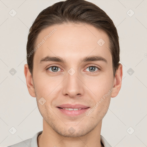 Joyful white young-adult male with short  brown hair and grey eyes