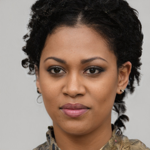 Joyful black young-adult female with medium  brown hair and brown eyes