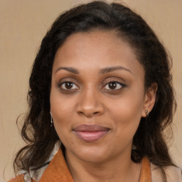 Joyful latino adult female with medium  brown hair and brown eyes