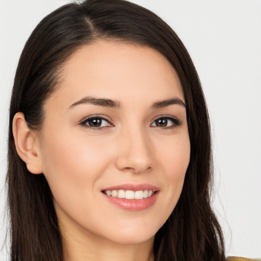 Joyful white young-adult female with long  brown hair and brown eyes