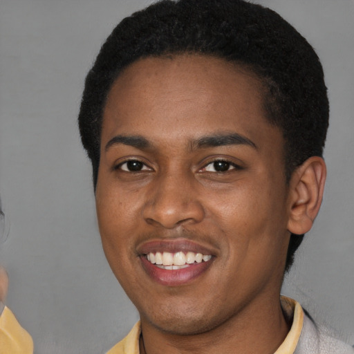 Joyful latino young-adult male with short  brown hair and brown eyes