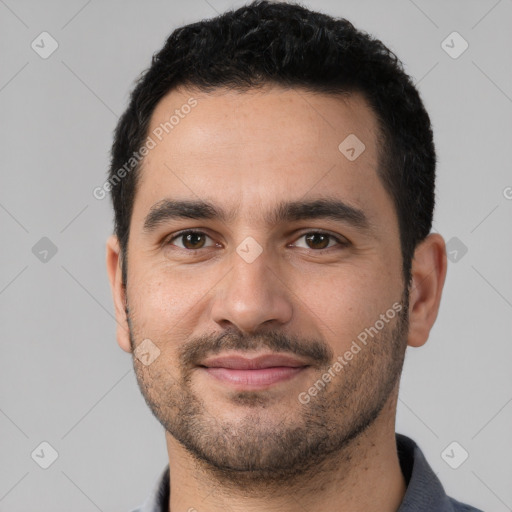 Joyful white young-adult male with short  black hair and brown eyes