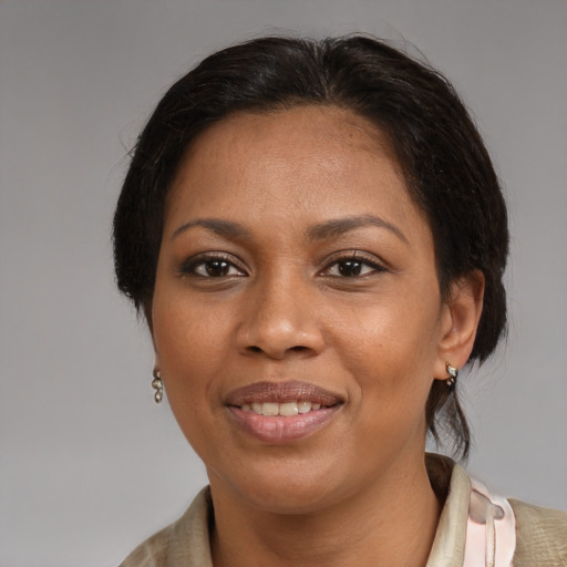 Joyful latino adult female with medium  brown hair and brown eyes