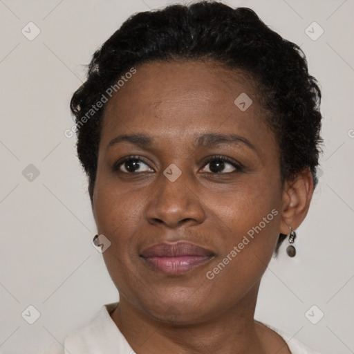 Joyful black adult female with short  brown hair and brown eyes