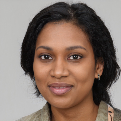 Joyful black young-adult female with medium  black hair and brown eyes