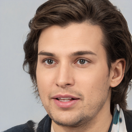 Joyful white young-adult male with medium  brown hair and brown eyes