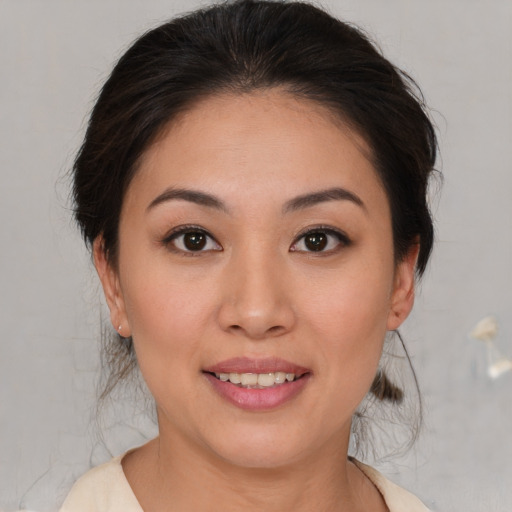 Joyful asian young-adult female with medium  brown hair and brown eyes