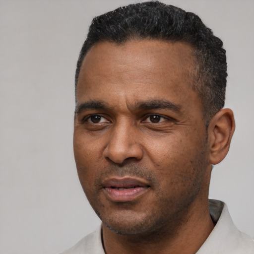 Joyful latino adult male with short  black hair and brown eyes