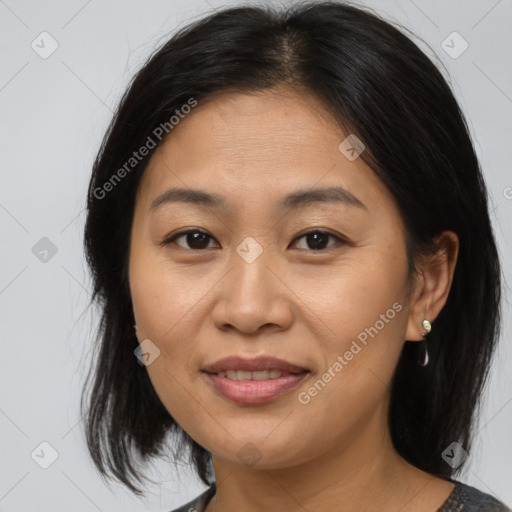 Joyful asian adult female with medium  brown hair and brown eyes