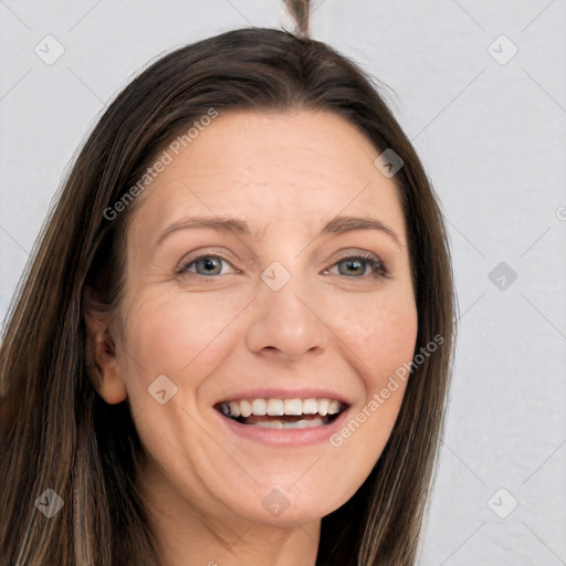 Joyful white adult female with long  brown hair and grey eyes