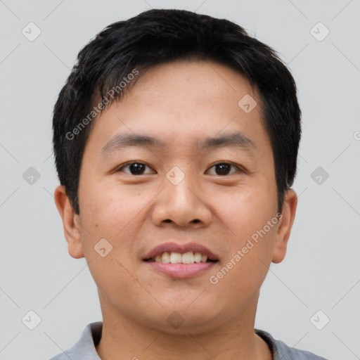 Joyful asian young-adult male with short  black hair and brown eyes