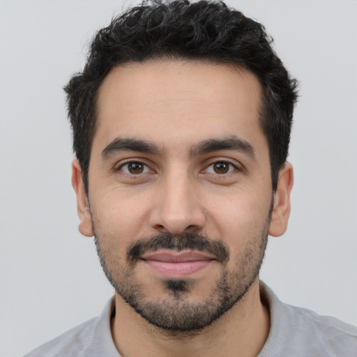 Joyful white young-adult male with short  black hair and brown eyes
