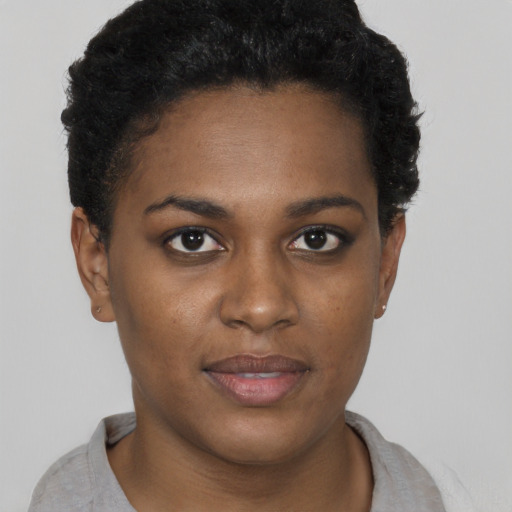 Joyful black young-adult female with short  brown hair and brown eyes