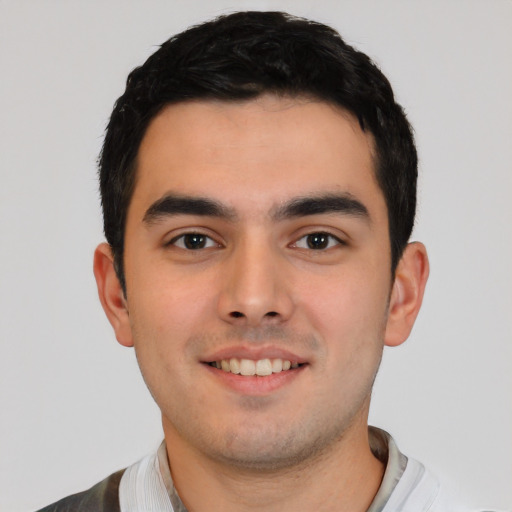 Joyful white young-adult male with short  black hair and brown eyes