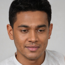 Joyful latino young-adult male with short  black hair and brown eyes