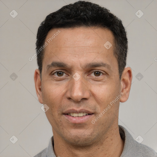 Joyful white adult male with short  black hair and brown eyes