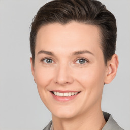 Joyful white young-adult female with short  brown hair and grey eyes