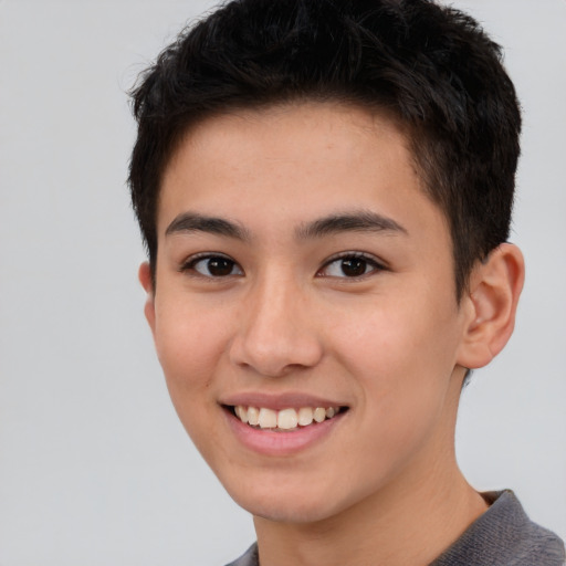 Joyful asian young-adult male with short  brown hair and brown eyes