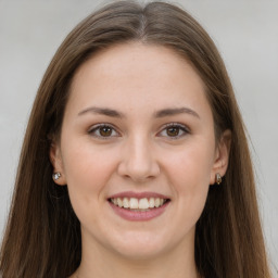 Joyful white young-adult female with long  brown hair and grey eyes