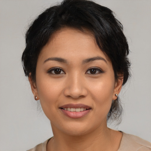 Joyful latino young-adult female with medium  brown hair and brown eyes