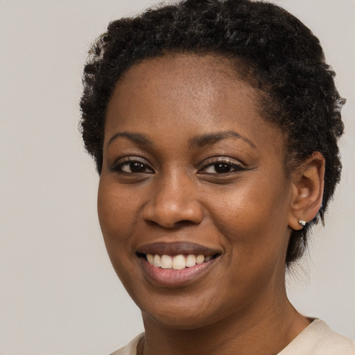 Joyful black young-adult female with short  brown hair and brown eyes