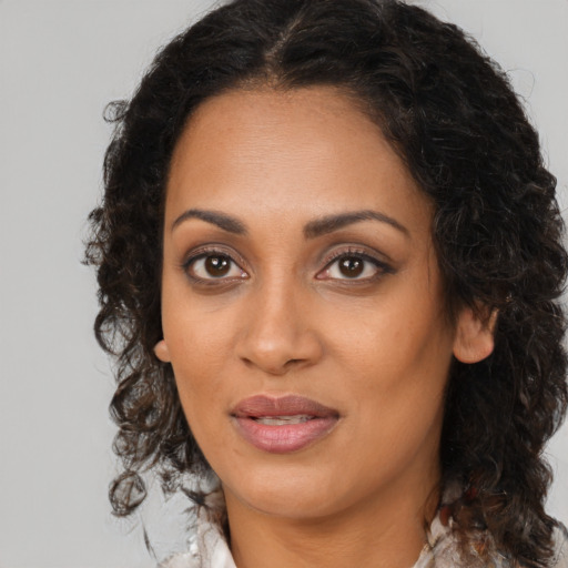 Joyful black young-adult female with medium  brown hair and brown eyes