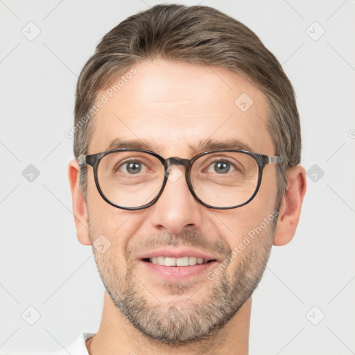 Joyful white adult male with short  brown hair and brown eyes