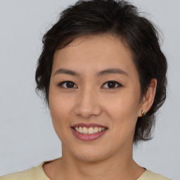 Joyful asian young-adult female with short  brown hair and brown eyes