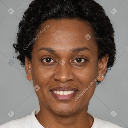 Joyful black adult female with short  brown hair and brown eyes