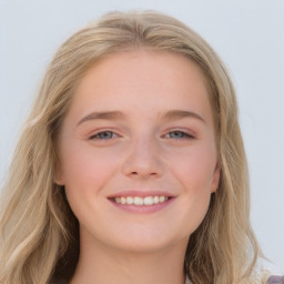 Joyful white young-adult female with long  brown hair and blue eyes