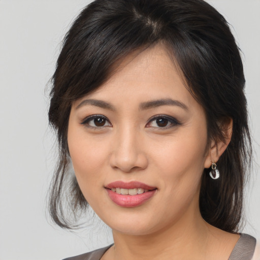 Joyful asian young-adult female with medium  brown hair and brown eyes