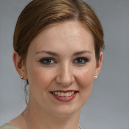 Joyful white young-adult female with medium  brown hair and grey eyes