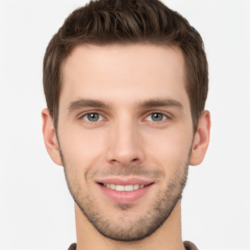 Joyful white young-adult male with short  brown hair and brown eyes