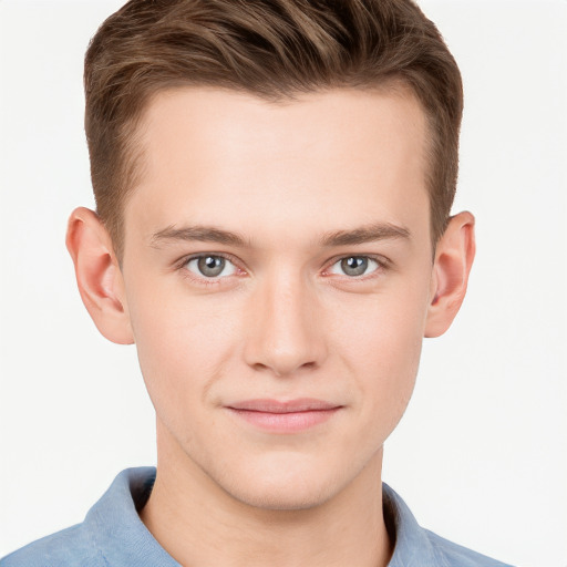 Joyful white young-adult male with short  brown hair and grey eyes